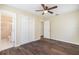 Bedroom with wood-look floors, ceiling fan and access to bathroom at 4918 Cresthill Dr, Tampa, FL 33615