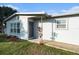 Newly renovated home with gray accents and a landscaped yard at 4918 Cresthill Dr, Tampa, FL 33615