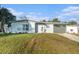 Newly renovated home with gray accents and a landscaped yard at 4918 Cresthill Dr, Tampa, FL 33615