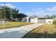 Newly renovated home with gray accents and a landscaped yard at 4918 Cresthill Dr, Tampa, FL 33615