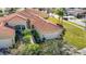 Attractive home with tile roof, two-car garage, and lush landscaping at 4935 Marble Springs Cir, Wimauma, FL 33598