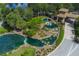 Aerial view of community entrance with pools and landscaping at 4935 Marble Springs Cir, Wimauma, FL 33598