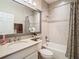 Clean bathroom with a shower/tub combo and granite countertop at 4935 Marble Springs Cir, Wimauma, FL 33598