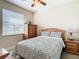 Cozy bedroom with a queen-size bed and wooden furniture at 4935 Marble Springs Cir, Wimauma, FL 33598