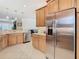 Kitchen with stainless steel appliances and light wood cabinets at 4935 Marble Springs Cir, Wimauma, FL 33598