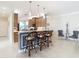 Kitchen with breakfast bar, pendant lighting, and light colored cabinetry at 4935 Marble Springs Cir, Wimauma, FL 33598