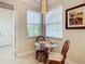 Bright kitchen nook with glass table and chairs, offering a casual dining space at 4935 Marble Springs Cir, Wimauma, FL 33598