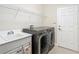 Laundry room with washer, dryer and utility sink at 4935 Marble Springs Cir, Wimauma, FL 33598