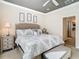 Bright bedroom with king bed, gray decor, and ceiling fan at 4935 Marble Springs Cir, Wimauma, FL 33598