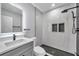 Modern bathroom with gray vanity, marble shower, and black accents at 5425 36Th N Ave, St Petersburg, FL 33710