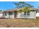 Newly renovated house with red door, landscaping, and a spacious front yard at 5425 36Th N Ave, St Petersburg, FL 33710