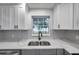 Modern kitchen with gray cabinets, white quartz countertops, and a farmhouse sink at 5425 36Th N Ave, St Petersburg, FL 33710