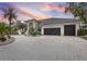 Luxury home with circular driveway, lush landscaping, and captivating sunset views at 5801 Leeland S St, St Petersburg, FL 33715