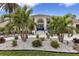 Elegant home exterior featuring a blue front door and beautifully landscaped entryway at 5801 Leeland S St, St Petersburg, FL 33715