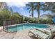 Relaxing pool area with lounge chairs and a safety fence at 5801 Leeland S St, St Petersburg, FL 33715