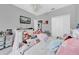 Bright bedroom with a double bed, plush toys, and plenty of storage at 614 105Th N Ln, St Petersburg, FL 33716