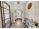 Bright and airy entryway with wood floors and a glass-top table at 614 105Th N Ln, St Petersburg, FL 33716