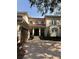 Front view of a two-story house with a wooden door and a paved driveway at 6534 Bayshore Blvd, Tampa, FL 33611