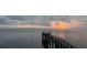 Sunrise over calm water with a wooden dock extending into the water at 6534 Bayshore Blvd, Tampa, FL 33611