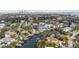 Aerial perspective of a house by the water, with a cityscape backdrop at 660 Geneva Pl, Tampa, FL 33606