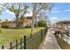 Landscaped backyard with a canal-side walkway and fence at 660 Geneva Pl, Tampa, FL 33606