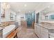 Elegant bathroom with double vanities, a soaking tub, and a walk-in shower at 660 Geneva Pl, Tampa, FL 33606