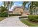 Two-story house with a tile roof, driveway, and lush landscaping at 660 Geneva Pl, Tampa, FL 33606