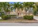 Tan two-story house with palm trees and manicured landscaping at 660 Geneva Pl, Tampa, FL 33606