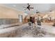 A living room under renovation, with exposed walls and flooring, and ceiling fans at 660 Geneva Pl, Tampa, FL 33606