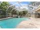 Inviting screened pool and spa with a large patio area at 660 Geneva Pl, Tampa, FL 33606