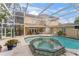 Enclosed pool and spa with a spiral staircase and patio area at 660 Geneva Pl, Tampa, FL 33606