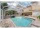 Inviting screened pool and spa with a large patio area at 660 Geneva Pl, Tampa, FL 33606