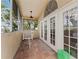 Bright screened porch with french doors and a tiled floor at 660 Geneva Pl, Tampa, FL 33606