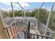 Spiral staircase leading down to the pool and patio area at 660 Geneva Pl, Tampa, FL 33606