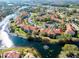 Aerial view of a waterfront community with landscaping, a lake, and parking at 6816 Dali Ave # E206, Land O Lakes, FL 34637