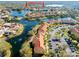 Aerial view showcasing condo community by lake with resort-style amenities at 6816 Dali Ave # E206, Land O Lakes, FL 34637