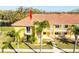 Aerial view of condo building near lake with palm trees at 6816 Dali Ave # E206, Land O Lakes, FL 34637