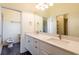 Bathroom with double vanity, modern fixtures, and a large mirror with great lighting at 6816 Dali Ave # E206, Land O Lakes, FL 34637