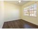 Bright bedroom featuring wood-look flooring and large windows at 6816 Dali Ave # E206, Land O Lakes, FL 34637