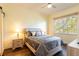 Bright bedroom with a queen-size bed and wood floors at 6816 Dali Ave # E206, Land O Lakes, FL 34637