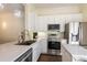 Stylish kitchen featuring stainless steel appliances and white cabinetry at 6816 Dali Ave # E206, Land O Lakes, FL 34637