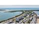 An aerial view showcasing the condo building's location near the water and a road at 7 Elgin Pl # 701, Dunedin, FL 34698