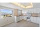 Bright kitchen featuring white cabinets, granite counters, and a water view at 7 Elgin Pl # 701, Dunedin, FL 34698