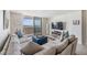 Bright living room with ocean view, comfy sectional sofa, and large TV at 7 Elgin Pl # 701, Dunedin, FL 34698