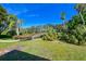 Backyard with wooden bridge, lush landscaping, and palm trees at 7402 Hamilton Rd, Bradenton, FL 34209