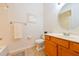 Clean bathroom with wood vanity, tile floor and a large mirror at 7402 Hamilton Rd, Bradenton, FL 34209