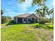 Single-Gathering home with lush lawn, screened patio and palm trees at 7402 Hamilton Rd, Bradenton, FL 34209