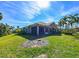 Single-Gathering home with a screened patio and palm trees at 7402 Hamilton Rd, Bradenton, FL 34209