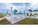 Outdoor grilling area with tables, benches, and umbrellas at 868 Bayway Blvd # 312, Clearwater Beach, FL 33767