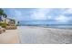 Peaceful sandy beach with benches and waterfront view at 868 Bayway Blvd # 312, Clearwater Beach, FL 33767